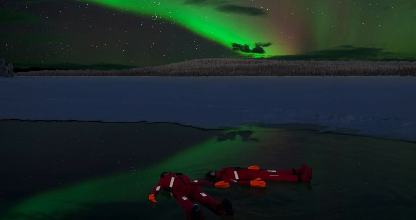 Ice Floating in Forest Lake with Aurora Borealis